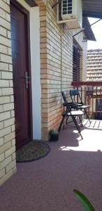 a door to a patio with two chairs and a table at Apartment Dukat Vršac in Vršac