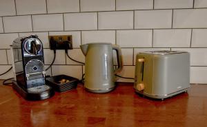 two appliances sitting on a counter next to a toaster at Holdens Cottage in Whitstable