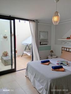 a bedroom with a bed with two towels on it at casa Emilia Cotillo Mar in Cotillo +25 photos