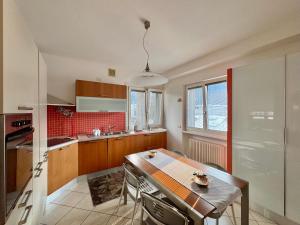 a kitchen with a table and a counter top at 1Dest - Garda Flow in Riva del Garda