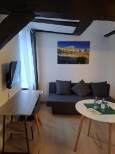 a living room with a couch and a table at Deutsche Eiche Hotel & Restaurant in Grebenstein
