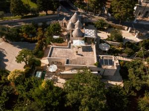 an overhead view of a mansion with a church at I Trulli del Tupparello in Fasano
