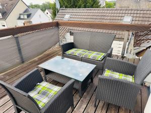 a patio with chairs and a table on a deck at Apartment mit Balkon an der Mosel in Koblenz-Güls in Koblenz