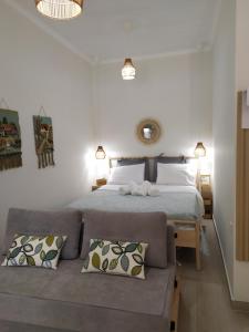a bedroom with a large bed and a couch at Tennis Home-Pozar, Piperia! in Áno Rodoniá