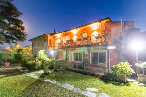 a house with a balcony on the side of it at Casa Fra Gli Ulivi with Private Pool - Chicca in Ameglia