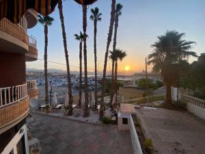 a view from the balcony of a building with palm trees at Adorable Apartamento en la Playa in Puerto de Mazarrón