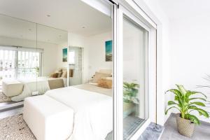 a bedroom with a white bed and a large window at Aroeira Luxury Azul Villa, Lisboa, Beach, Surfing, Golf, Exploring, Hiking, Fishing in Charneca +56 photos