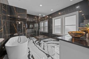 a bathroom with a tub and a sink and a toilet at Tranquil Escape- Spa Bath & Pool for One or Couples in Houston +21 photos