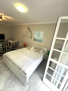 a bedroom with a bed and a desk and a table at SkyRest Bollullos in Bollullos de la Mitación +86 photos