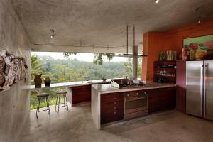 cocina con nevera de acero inoxidable y ventana en Umah Tampih Luxury Private Villa - CHSE Certified, en Ubud