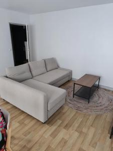 a living room with a couch and a coffee table at Beau T2 hyper centre face à la gare in Lille