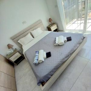une chambre avec un lit avec deux oreillers dessus dans l'établissement Cydonia Gardens Maisonette with shared pool, à Limassol