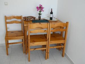 a table with two chairs and a bottle of wine at Castle View Apartments in Haraki