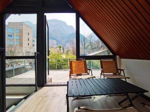 two chairs sitting in a room with a large window at 华山隐泉禅境 山景观星禅修别墅 Hua Shan Hidden Spring Restore Villa in Huayin
