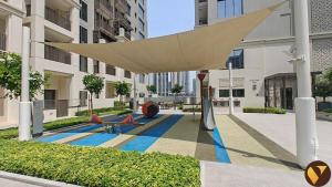 awning over a courtyard in a building at Vogue Rosewater Two Bedroom Apartment at Dubai Creek Harbour with Balcony and access to Pool, Gym, Kids Area and Near Shopping in Sabkhah