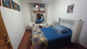 a bedroom with a blue bed and a mirror at L'Ulivo, alloggio in seminterrato in Fornello