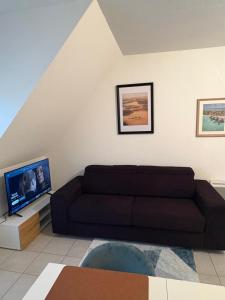 a living room with a couch and a flat screen tv at Perfect quiet getaway in Digoin