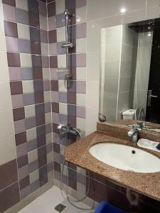 a bathroom with a sink and a shower at Cecilia Resort in Hurghada