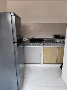 a kitchen with a stainless steel refrigerator at LA MEDELLIN HOSTAL in Cartagena de Indias