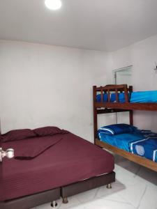 a bedroom with two bunk beds and a mirror at LA MEDELLIN HOSTAL in Cartagena de Indias