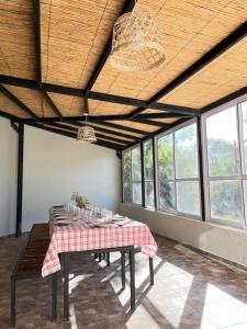 a dining room with a table with a checkered table cloth at Casa Lalina in Laprida