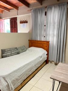 a bedroom with a bed and a window at Casa Lalina in Laprida