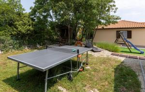 a ping pong table in a yard with a playground at Beautiful Home In Kunj With Wifi in Kunj