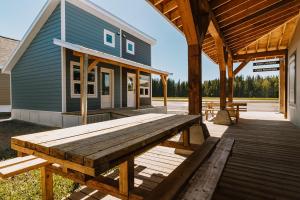 a large wooden picnic table on a porch of a house at Bikepack Basecamp in Nordegg
