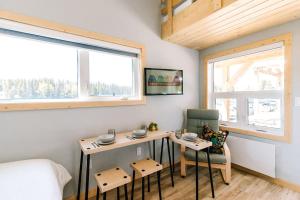 a room with a table and a chair and a bed at Bikepack Basecamp in Nordegg