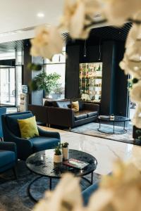 a living room with couches and a table at Favor Park Hotel in Kyiv