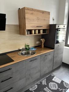 a kitchen with a sink and a counter top at FeWo Peters - Zentral gelegen in Wilhelmshaven