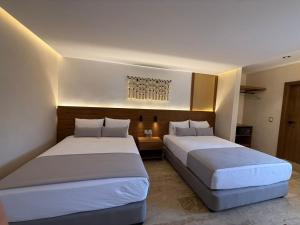 Postel nebo postele na pokoji v ubytování Hotel Makkan Boca