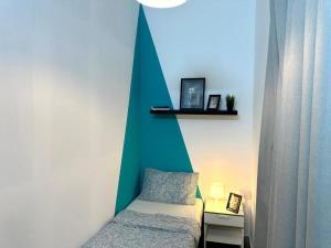 a bedroom with a bed with a green accent wall at delightful Partition Room Barsha Heights Tecom in Dubai +28 photos