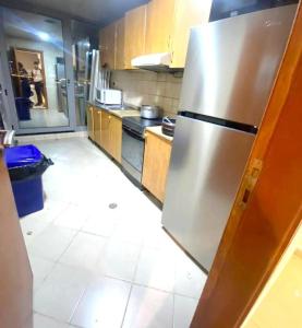 a kitchen with a stainless steel refrigerator in it at delightful Partition Room Barsha Heights Tecom in Dubai
