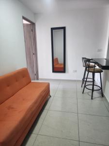 a living room with a couch and a table at Apartaestudio 201 Moderno y acogedor in Tuluá