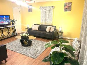 a living room with a couch and a table at Spacious Family Stay, Large Dining,3 Cozy Bedrooms in Hampton