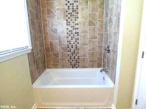 a bath tub in a bathroom with a shower at Spacious Family Stay, Large Dining,3 Cozy Bedrooms in Hampton +6 photos