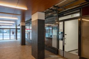 an empty lobby of a building with glass doors at SELF-SERVICE penthouse studio in the heart of Turku! in Turku