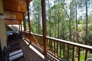 a porch of a cabin with a view of the woods at SunRidge at Willow Cove in Bass Lake