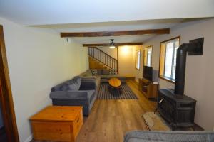 a living room with a couch and a stove at SunRidge at Willow Cove in Bass Lake