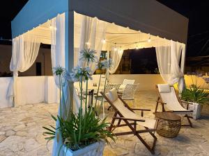 a table and chairs under a tent with plants at Mediterranean Villa Old Town in Vlorë