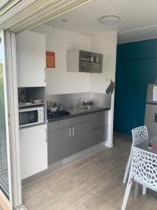 a kitchen with a sink and a stove top oven at T2 Beausoleil in Les Abymes