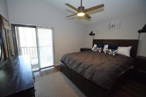 a bedroom with a bed and a ceiling fan at SunRidge at Willow Cove in Bass Lake