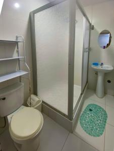 a bathroom with a shower and a toilet and a sink at Casa Real - Oxapampa BnB in Oxapampa +6 photos