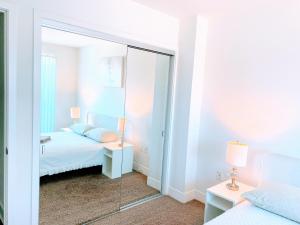 a mirror in a bedroom with a bed and a bed and a bed at Western Monroe in Los Angeles