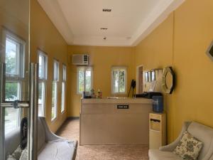 a kitchen with a counter and some chairs in a room at Reef Waters Resort in Pilar