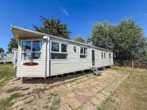 a white mobile home sitting in a yard at Lovely 8 Berth Caravan At Valley Farm Holidaypark Ref 46829V in Great Clacton