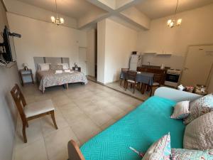 a living room with a couch and a bedroom at Ak´Para in Tandil +71 photos