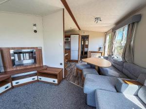 a living room with a couch and a table at Lovely 8 Berth Caravan At Valley Farm Holidaypark Ref 46829V in Great Clacton