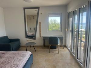 a bedroom with a bed and a desk and a mirror at Vila Natalia in Petrovac na Moru